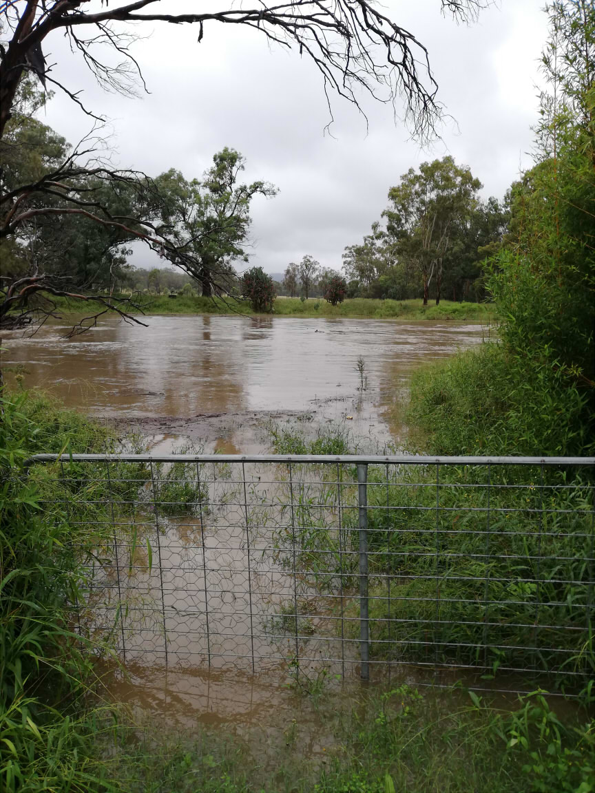Floodwater reaches past a gate