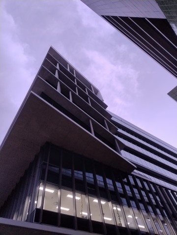 Pink sky behind a looming building