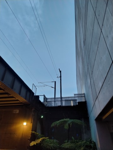 Cold blue sky beside a rail bridge