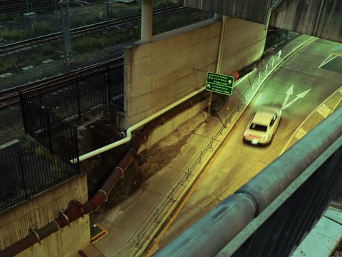 A blurry car leaves a tunnel