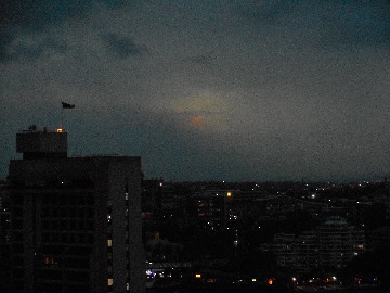 Darkness encloses an orange cloud